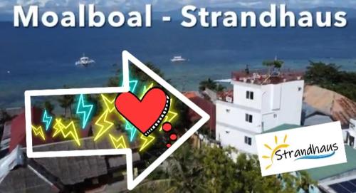 a sign that says modern standards with a picture of a heart at Strandhaus Condotel in Moalboal