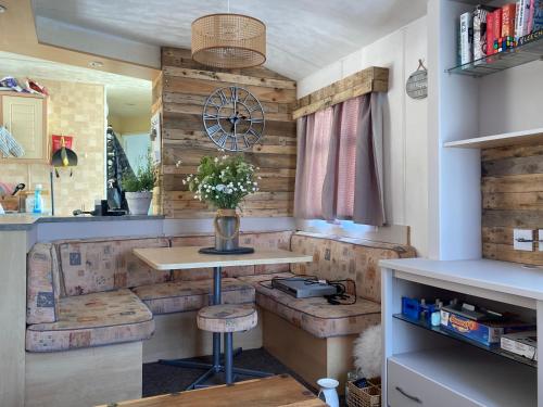 a kitchen with a table and stools in a room at Trimingham Static Van in Trimingham