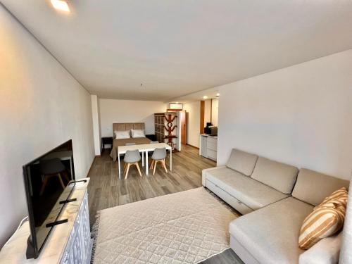a living room with a couch and a table at Charming Studio Apartment in Povoa de Varzim in Póvoa de Varzim