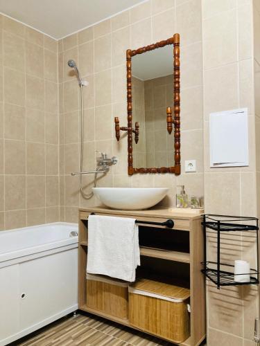 a bathroom with a sink and a mirror at Nākotnes street apartaments in Liepāja