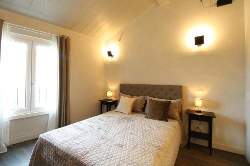 a bedroom with a bed with two night stands and a window at Elegant and Luxury Apartment @Altare della Patria in Rome
