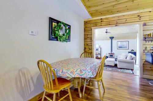 a dining room with a table and chairs and a living room at Schroon River Adventures in Warrensburg