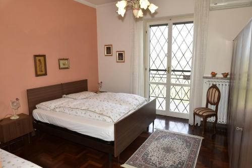 a bedroom with a bed and a large window at Casavacanzedezza in Montecalvo Versiggia