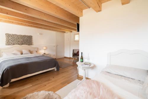 a bedroom with a large bed and wooden ceilings at Agriturismo Podere del Bosc in Valmareno