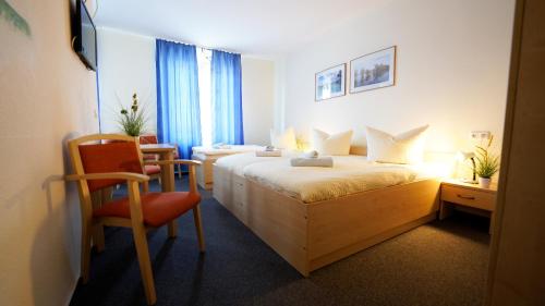 a hotel room with a bed and a chair at StroamCamp Schwedt - a84455 in Schwedt