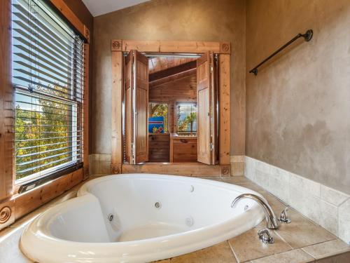 a bath tub in a bathroom with a window at Heaven's View, 2 Bedrooms, Sleeps 10, Hot Tub, Pool Table, Arcade, Jacuzzi in Gatlinburg