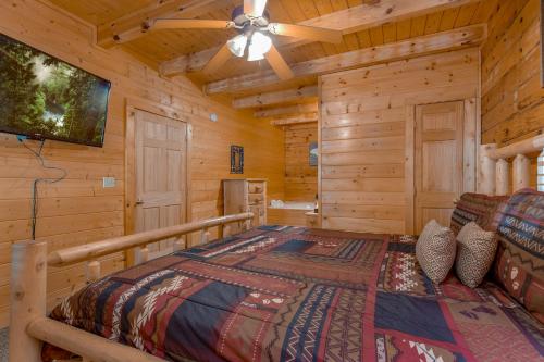 a bedroom with a bed in a log cabin at A Mountain Paradise, 2 Bedrooms, Sleeps 6, Pool Access, Hot Tub, Pool Table in Pigeon Forge