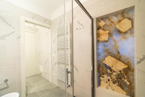 a shower with a glass door in a bathroom at Milan Design Suite - Palestra e Parcheggio Privato in Milan