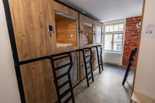 a group of bunk beds in a room at Capsule hostel Andel Centre SPIRIT in Prague