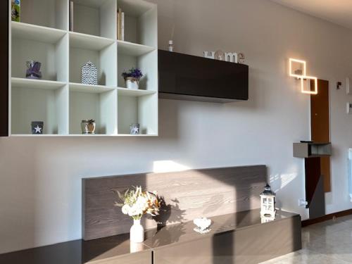 a living room with a counter with flowers on it at Residence Outlet Vivaldi in Noventa di Piave