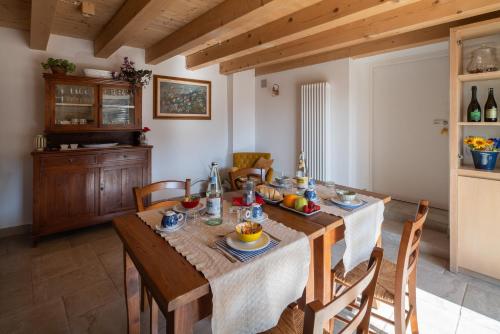 a dining room with a wooden table and chairs at Agriturismo Podere del Bosc in Valmareno