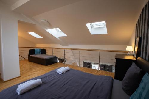 a bedroom with a bed and skylights in the ceiling at Riverside SPIRIT in Prague