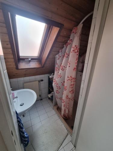 a bathroom with a sink and a window at TWO Self-Check-In, 3km freeway 