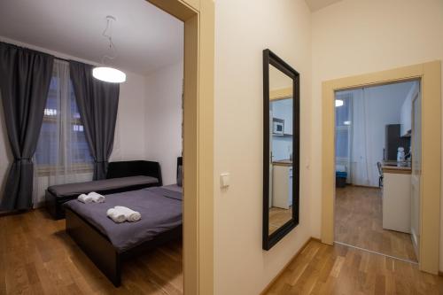 a small room with a bed and a mirror at Riverside SPIRIT in Prague