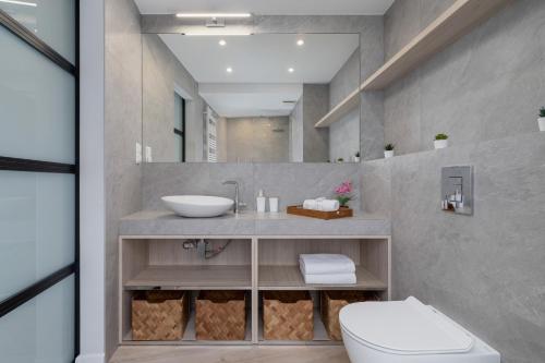 a bathroom with a sink and a toilet at Deluxe City Studio with Parking Kącik 10 by Renters in Krakow