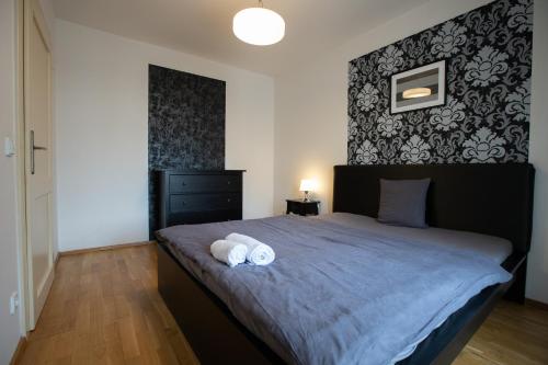 a bedroom with a bed with two towels on it at Riverside SPIRIT in Prague