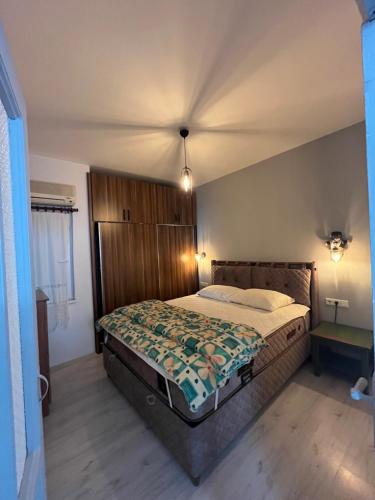 a bedroom with a large bed in a room at Centeral Apartment in Kaş