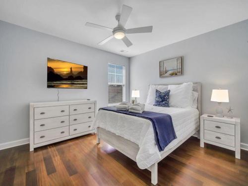 a bedroom with a bed and a ceiling fan at Coastal Quarters in Bluffton