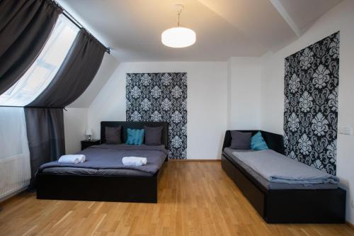 a bedroom with two beds and a window at Riverside SPIRIT in Prague