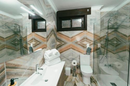 a bathroom with a toilet and a sink and a shower at Quinta da Costinha in Alijó