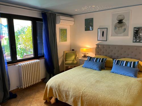 a bedroom with a large bed with blue pillows at Maison Du Soleil in Cima