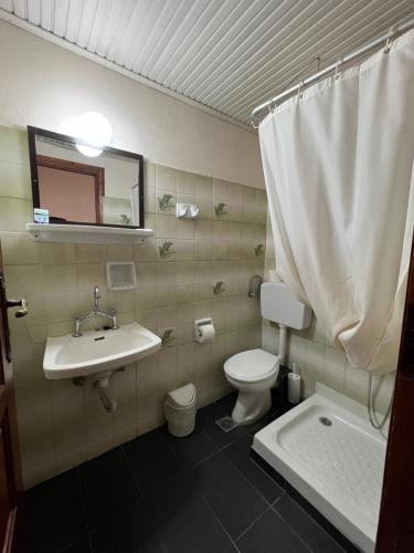 a bathroom with a sink and a toilet and a mirror at Rethymno House in Rethymno Town