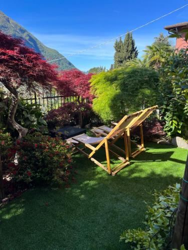 a wooden picnic table in the grass in a garden at Maison Du Soleil in Cima
