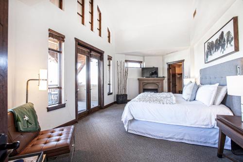 a bedroom with a white bed and a fireplace at Hyatt at the Canyons by Lespri Management in Park City