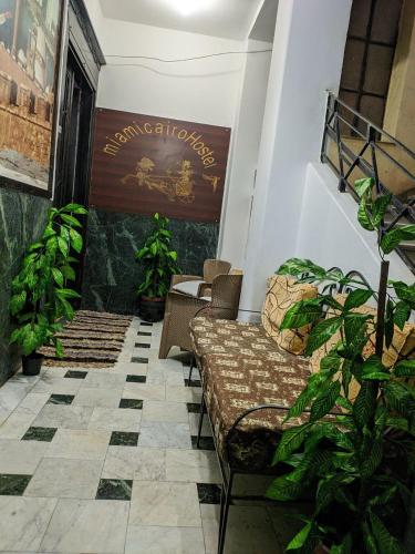 a waiting room with a couch and some plants at Miami Hotel in Cairo