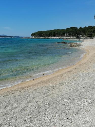 a sandy beach with the ocean in the background at Peponi Del Mar II in Biograd na Moru