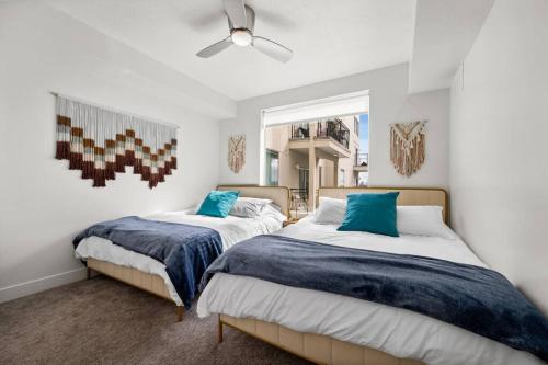 a bedroom with two beds and a ceiling fan at Urban Oasis in the Center of SLC in Salt Lake City