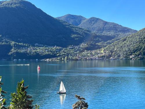 two boats on a lake with mountains in the background at Maison Du Soleil in Cima