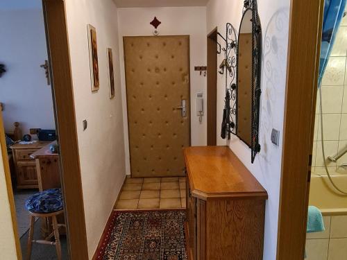 a hallway with a door leading to a room with a kitchen at Ferienwohnung Eckl in Bad Reichenhall