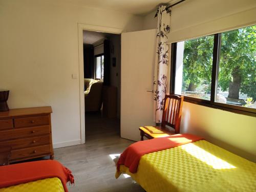 a bedroom with two beds and a window at Casita de invitados cerca de Madrid in Moralzarzal