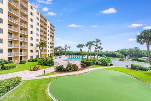 a resort with a golf course and a swimming pool at Canaveral Towers Resort-Beach, Surf, Rocket Launches in Cape Canaveral