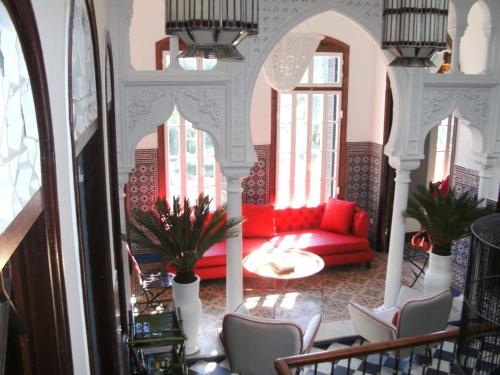 a living room with a red couch and chairs at SUMMER HOUSE TANGER in Tangier