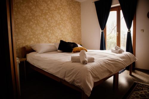 a bedroom with a bed with towels on it at Sipos Borház és Vendégház in Badacsonyörs