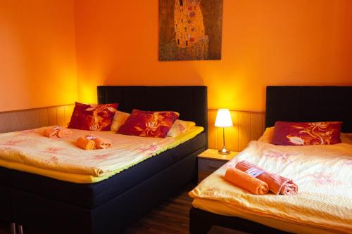 two beds sitting next to each other in a room at Hotel Rychta Netolice in Netolice