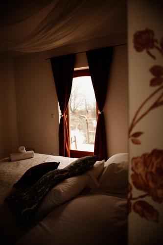 a bedroom with a bed and a window at Sipos Borház és Vendégház in Badacsonyörs