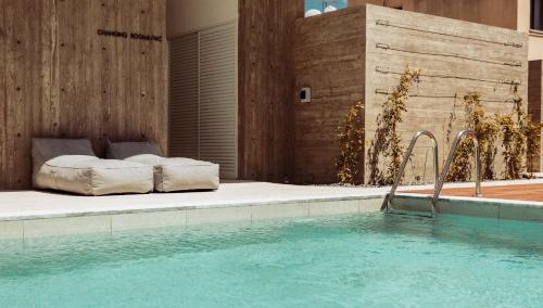 a bedroom with a bed next to a swimming pool at Regency Boutique Hotel Holiday Suites in Paphos