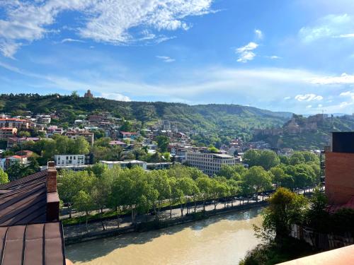 a view of a river with a city at Marmenio Hotel - Tbilisi in Tbilisi City