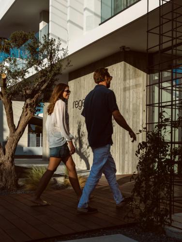 a man and a woman walking down a sidewalk at Regency Boutique Hotel Holiday Suites in Paphos