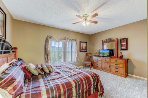 ピジョン・フォージにあるSmoky Mountain Dream Whispering Pines 641のベッドと天井扇風機のある寝室