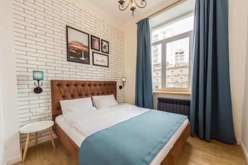 a bedroom with a large bed and a window at Scandinavian Apartments in Kyiv