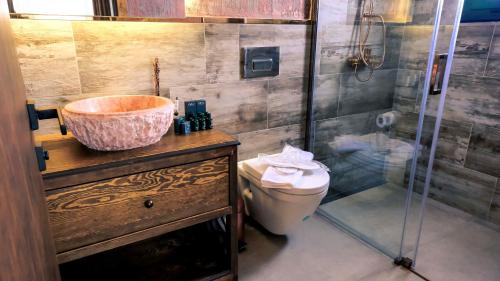 a bathroom with a sink and a toilet and a shower at Wind Of Alaçatı Adult Only 13 in Çeşme