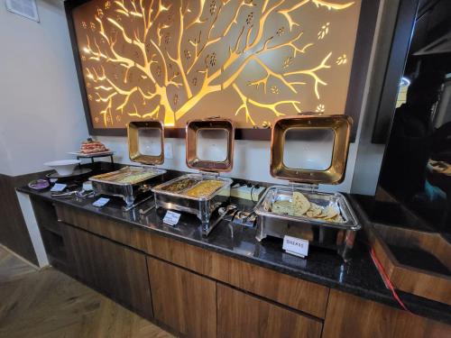 a buffet line with many different food items on it at Belvedere Suites in Greater Noida