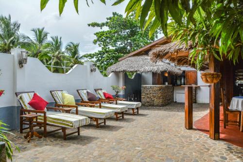 a row of chairs and tables on a patio at A casa di Giorgia lodge Nosy be Andilana in Nosy Be
