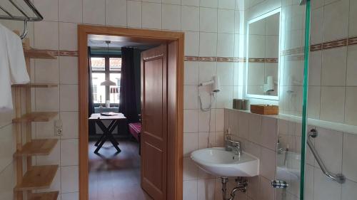 a bathroom with a sink and a mirror at Der grüne Fürst Ferienwohnung Appartement 1 in Bad Muskau