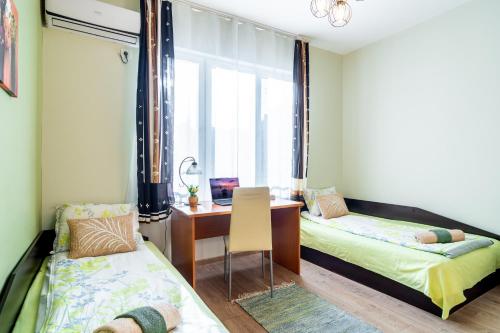 a room with two beds and a desk and a window at Madrid 2BDR w Free Parking near Metro, Serdika Mall in Sofia