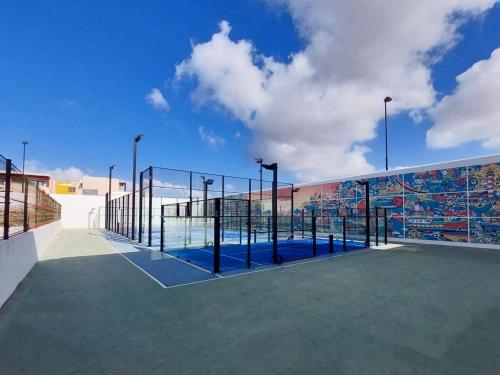a tennis court on a court with a blue sky at Coral Cotillo Beach in El Cotillo